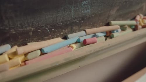 Close Up of Colorful Chalk on Chalkboard