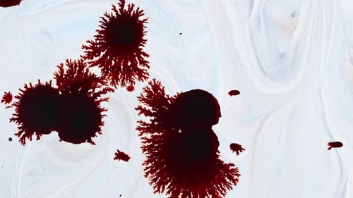 L'encre tombe et s'étale sur une surface blanche 16