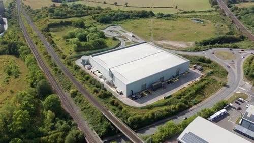 Aerial view of industrial building near railway, United Kingdom.