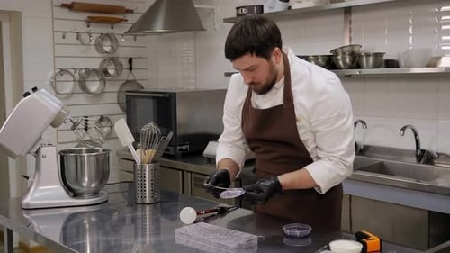 Closeup of a Pastry Chef Makes Handmade Chocolates in a Professional Pastry Shop
