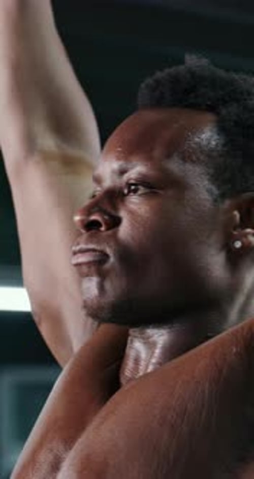 Strong, barbell and black man in gym, training and wellness with challenge, power and intensity