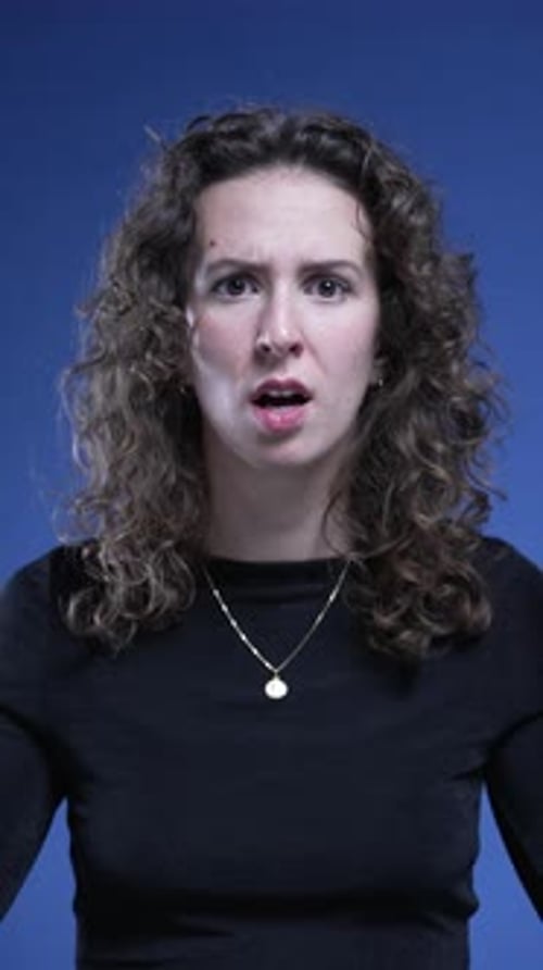 Woman Reacts in Shock Against Blue Background