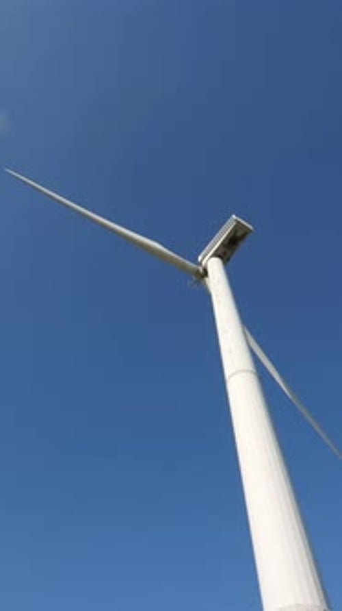 Vertical Video Wind Generator Works Against Blue Sky Blades of a Wind Generator