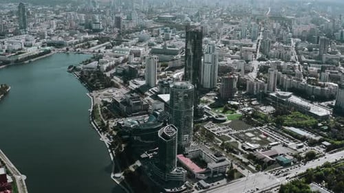 A built-up city under the bright sun. Stock footage. Huge glass offices and residential buildings