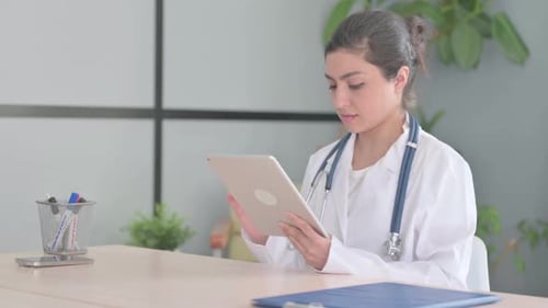 Female Doctor Uses Tablet in Modern Office