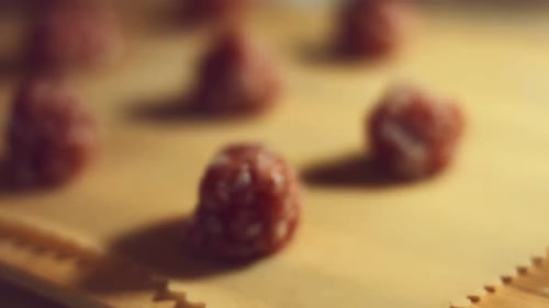 Raw Meatballs on Wooden Cutting Board Close-Up