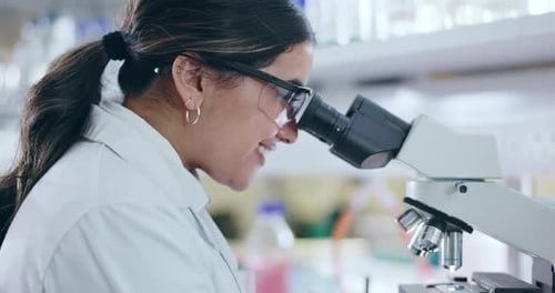 Scientist Using Microscope in Bright Laboratory