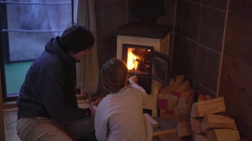Person and Child Cozy by a Wood Stove