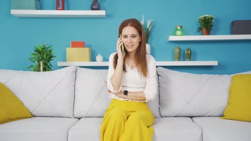 Worried Woman Receives Bad News on Phone at Home