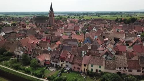 A panning forward drone shot of the fortified village of Bergheim, Haut-Rhin. It is a very pleasant
