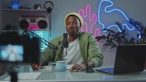 Vlogger Talking in Mic and Recording Video with Digital Camera at Studio
