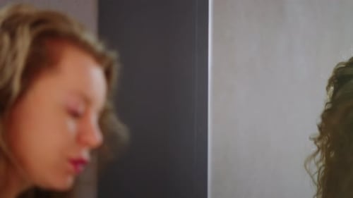 Young Woman Applying Makeup in Bathroom