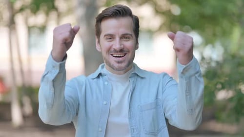 Cheerful Man Celebrates and Expresses Excitement