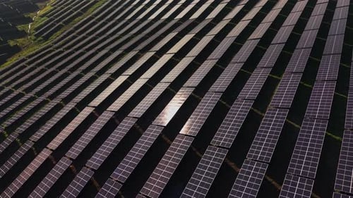 Large solar panel array captures sunlight at solar farm