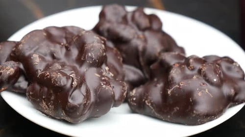 A Beautiful Plate Displaying Delicious ChocolateCovered Confections for Everyone to Enjoy