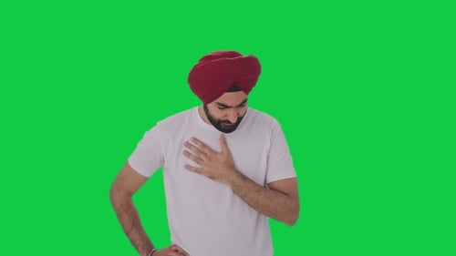 Sick Sikh Indian man suffering from cold and cough Green screen