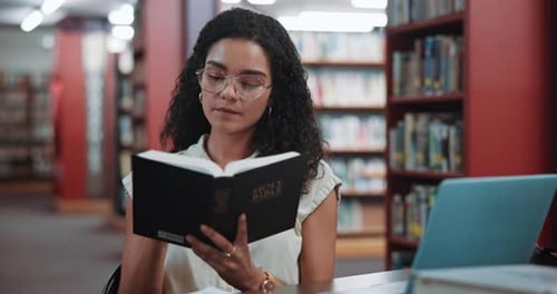 Library, knowledge and woman with bible, reading and personal devotion with scripture and religious