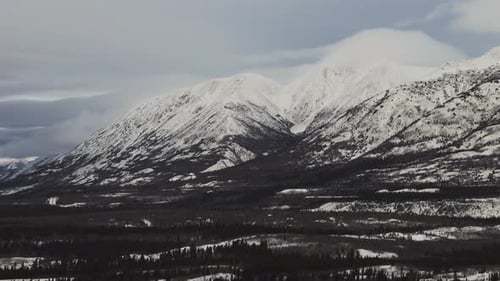 Snow-covered Mountain Range During Winter In Yukon, Canada. - aerial shot
