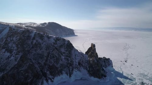 Aerial View of Cape Khoboy Olkhon Island Tall Rocks in Frozen Lake Baikal with Many People and Cars