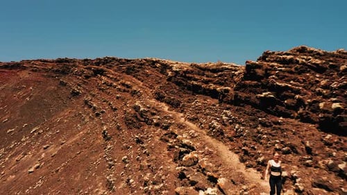 Woman Traveler Walking Through the Lava Field Crater of Calderon Hondo Volcano