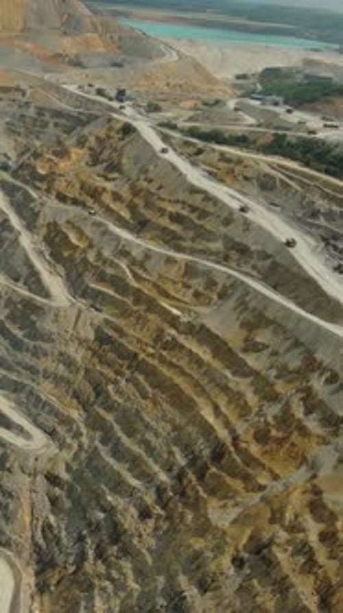 Aerial of open mine and heavy mining equipment