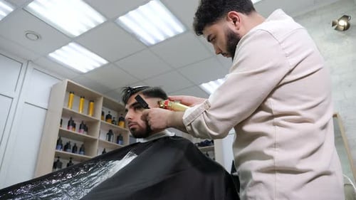 Barber Cuts Hair in Well-Lit Barber Shop