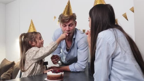 Family Celebrates Birthday with Cake