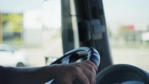 CloseUp of Hands Steering a Truck on the Road