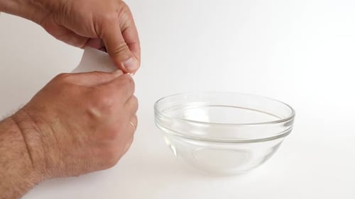 Hands Pouring Coffee Beans in Glass Bowl