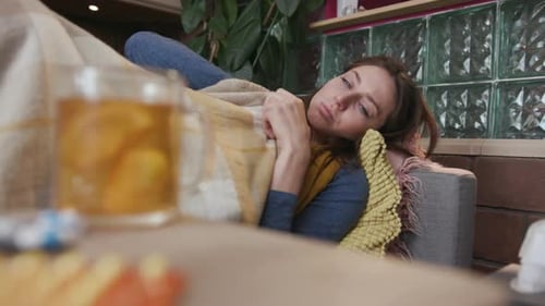 Close Up Young Sick Woman Lying on the Sofa Drink Tea Take Feel Sad Unhappy Virus Illness Cold Ill