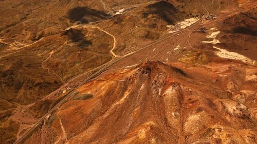 Flight above the lifeless arid landscape of Mojave desert.