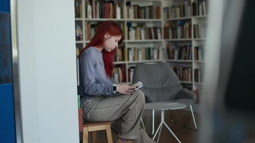 Pensive Young Girl Reading Book in Modern Library