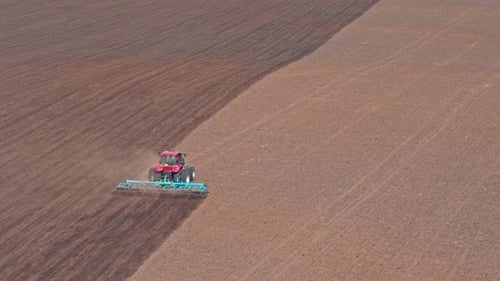 Tractor Plows A Field In The Spring