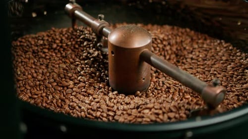 Roasted Coffee Beans Stirring in Metal Container