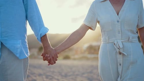 Mature married couple in love bonding outdoors at the beach