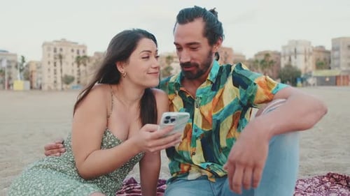 Romantic couple looking at photos on mobile phone