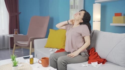 Sick young woman suffering from neck pain.