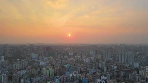 Amazing sunrise at a congested city. Aerial establishing ascending drone shot