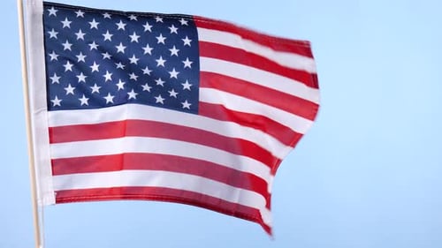 American Flag Waving Against a Clear Blue Sky