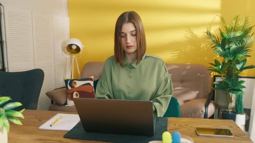 University Student Working on Laptop Focused Woman Making Notes in the Notebook