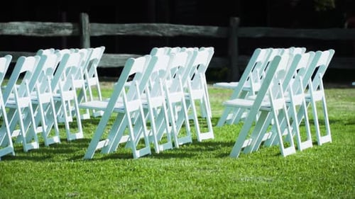 Rows of White Chairs on Green Grass
