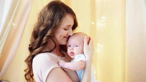 Loving Mother Holding Newborn Infant