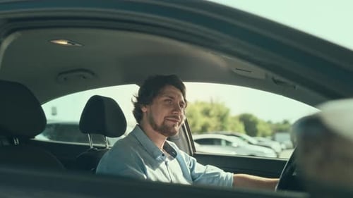 Man Driving a Car in the City