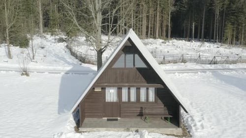 Rising Aerial Shot Of Ski Lodge In Winter Mountain Landscape, Wood Log Cabin Hut