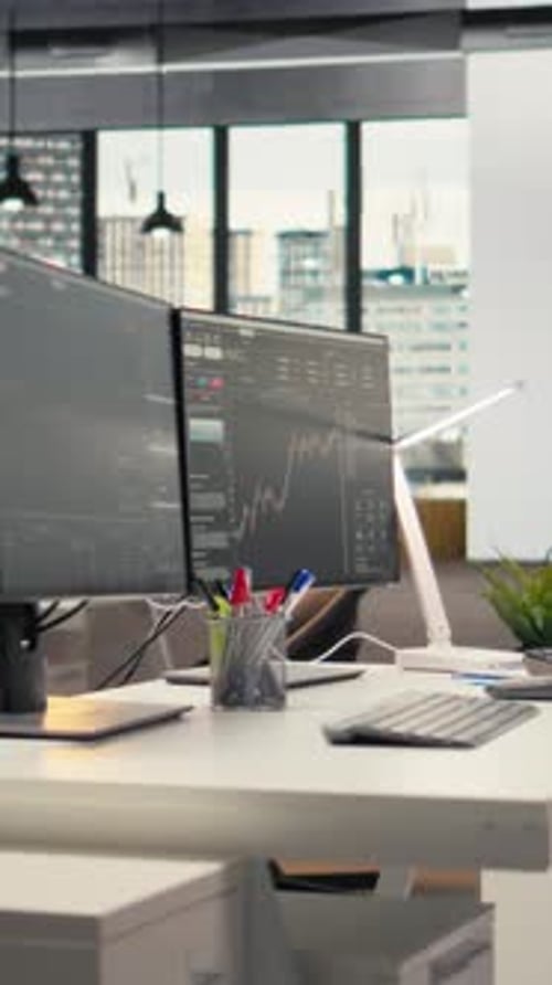 Vertical Video Stock Market Metrics Graphs Displayed on Computer Screens in Investment Firm