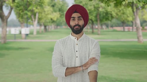 Happy Sikh Indian man getting ready to go out in park