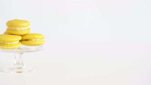 Delicious Yellow Macarons Stacked on a Glass Stand