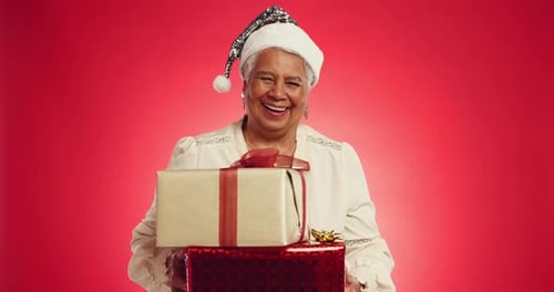 Gift, Christmas and face of old woman in studio for holiday season, retirement and mockup space