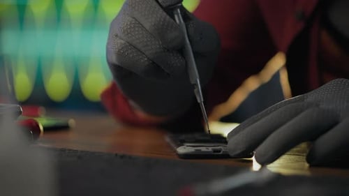 Electronics. A repairman uses skills and applies a screwdriver in an electronics service center. In
