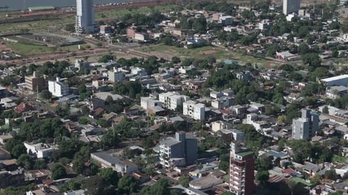 A shot from above of the city of Posadas Ciudad, Argentina. Houses are neighbouring with lush trees
